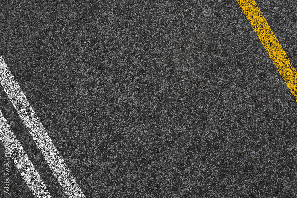 Fototapeta premium Double Yellow Line On New Asphalt Road texture background