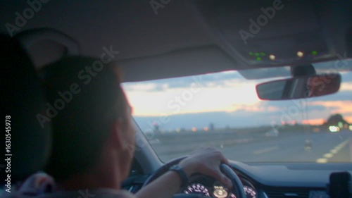 Wallpaper Mural A man travels alone on a highway, admiring a sunset. In the rearview mirror, he reflects on his life as night falls, revealing a starry road Torontodigital.ca