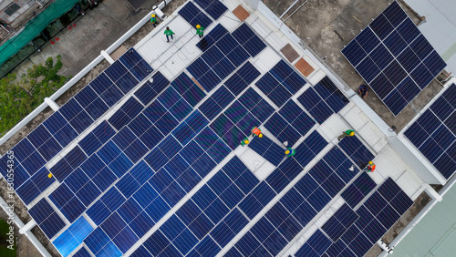 Solar module installation on a rooftop with workers engaging in renewable energy project
