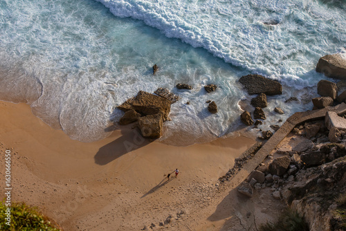The young couple is having fun on the beach, Nazare