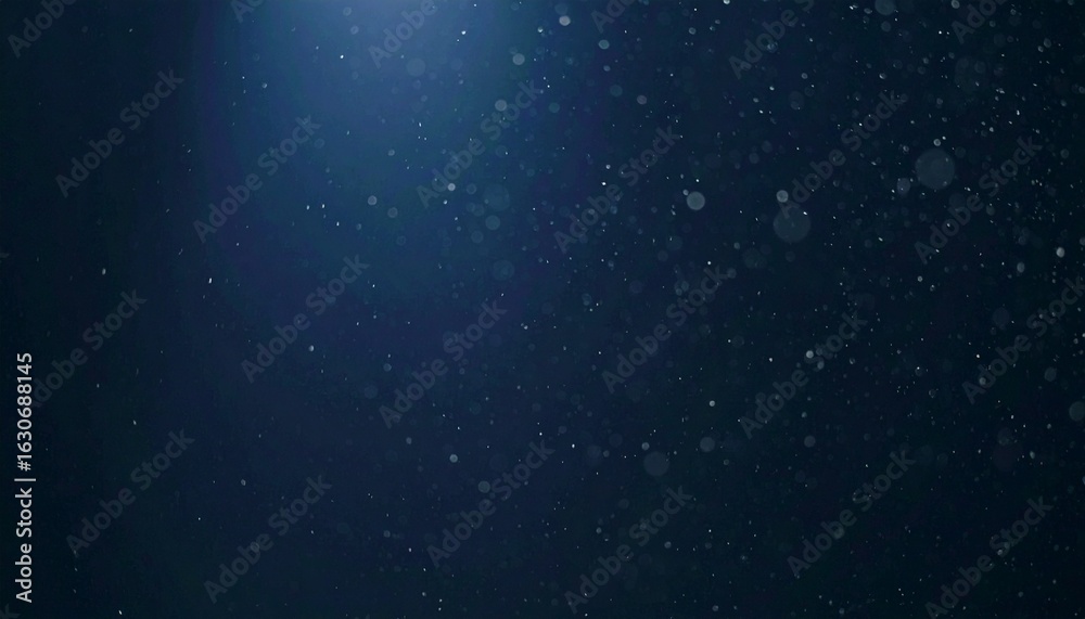 Obraz premium Floating dust particles illuminated by a single cinematic beam of light on a dark gradient background