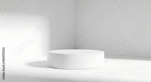 Minimalist white podium with soft shadows and natural light in a clean studio corner for product display