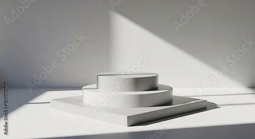 Minimalist geometric podium with dramatic diagonal shadow cast from window light on a clean white surface