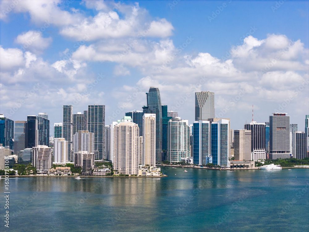 Naklejka premium Drone view of Brickell skyscrapers. Brickell cityscape of downtown Miami. Panoramic Miami Brickell skyline above the coastline. Brickell Key aerial view in Miami. Landscape of Miami.