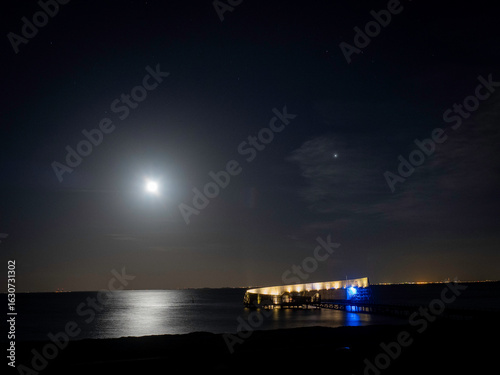 Moonlight shining on the Øresund sea at Kastrup Strandpark in Denmark