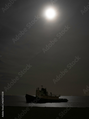 Abandoned ship with moonlight shining on the Øresund sea