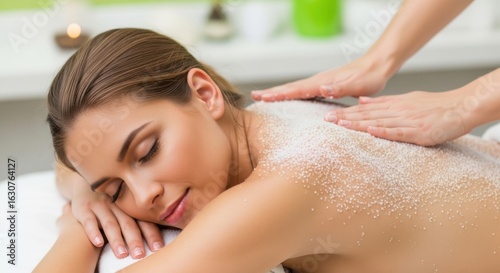 Woman receiving a relaxing exfoliating body scrub treatment at a spa