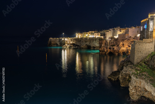 Night image of the beautiful and popular coastal town Polignano a mare in Italy.