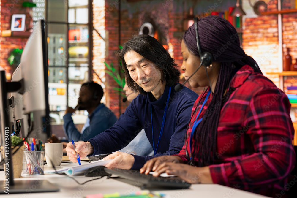Fototapeta premium Call center managers developing strategies to improve customer loyalty, looking over paperwork. Customer support management team implementing procedures for better client issue resolution