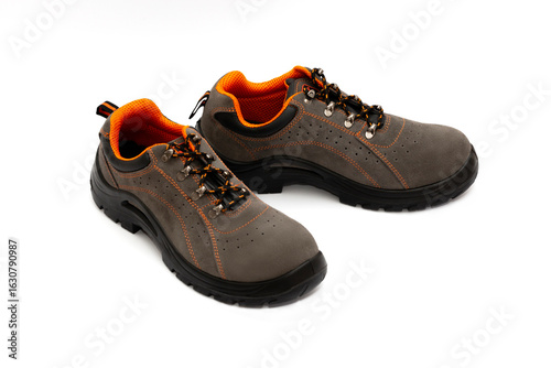 Brown safety leather work shoes with non-slip soles isolated on white background for men in factory or industry safety