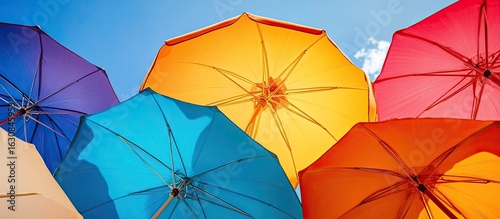 Colorful Open Umbrellas Against Sunny Blue Sky Low Angle View