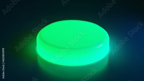 Green glowing button on dark reflective surface
