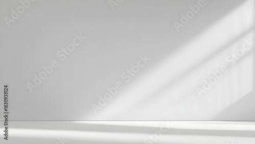 Wallpaper Mural Light and Shadow: Elegant minimalism shines as natural light streams through a window, casting intriguing shadows across a pristine wall and floor, creating a sense of tranquility and spaciousness. Torontodigital.ca