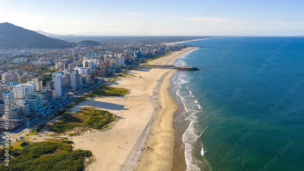 Fototapeta premium Aerial view of Caiobá Beach and cityscape in Matinhos, Paraná, Brazil, on a sunny day.