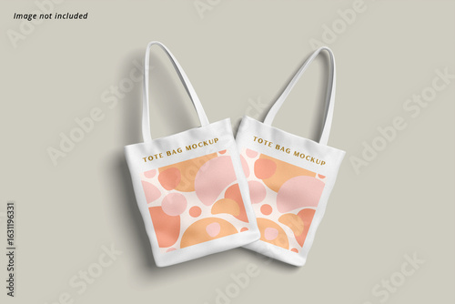 Minimalist mockup of two white fabric tote bags with a contemporary abstract pattern. Ideal for presenting custom shopping bag designs.