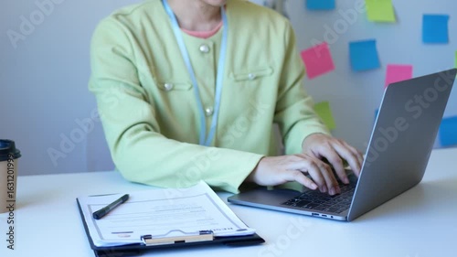 Young businesswoman holds a resume and evaluates it. Views the personal history of job applicants. Recruitment concept.