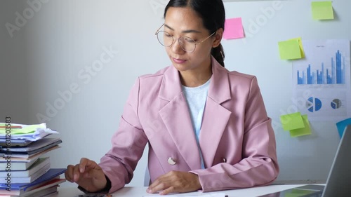 An office lady who has been sitting at work all day feels sore and aches. She stretches to relax her muscles and feels better and more comfortable at work.