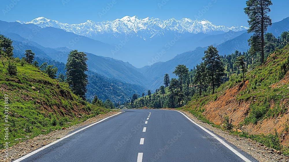 Fototapeta premium Mountain Majesty: Winding Road Through Lush Valley to Snowy Peaks