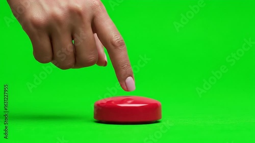 A person's finger presses a large red button. Isolated on a green screen, this action is ideal for concepts of making a decision, starting a process, or hitting an alert. Perfect for chroma key compos