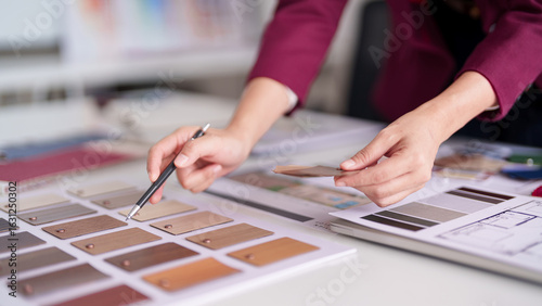 Asian adult professional architect selects interior design material color palette for home renovation property development