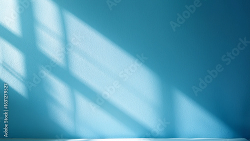 Sunlight streaming through blinds on bright blue wall. Clean, fresh interior background.