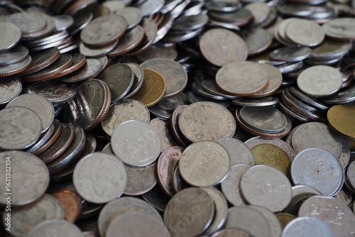 A pile of coins with many coins from Thailand