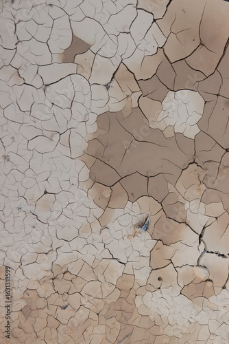 The empty rural road is very dry and broken because of the heat.