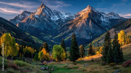 Mountain peaks rise above a valley bathed in autumnal hues