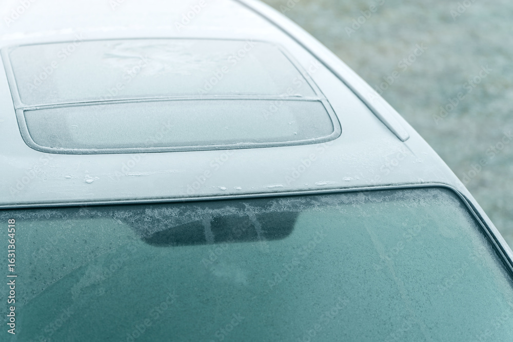 Obraz premium Thick ice layer on car windshield in wintertime