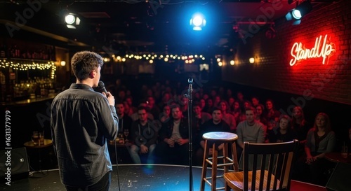 Male comedian on stage with microphone performing a 