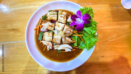 Spicy Thai squid roe salad, bold flavors, authentic Thai cuisine.