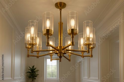 Elegant gold chandelier illuminating hallway with bright lights