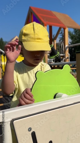 Little boy is playing outdoors. Kid on a playground in the park