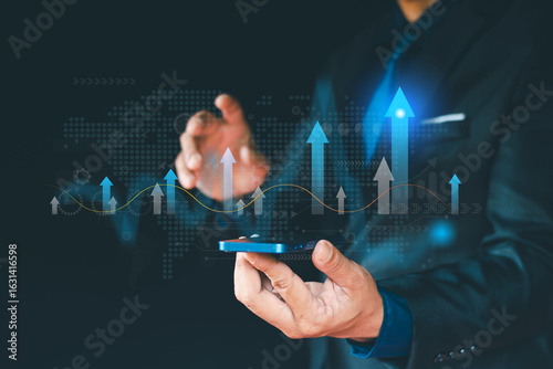 Businessman holding business growth graph, growth strategy and goal achievement with up arrow. Business strategy development and growth plan.