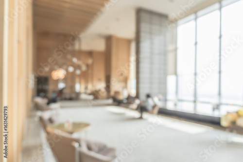 Blurred business office building lobby or hotel blur background interior view toward reception hall, modern luxury lounge, white room space with blurry corridor and glass wall