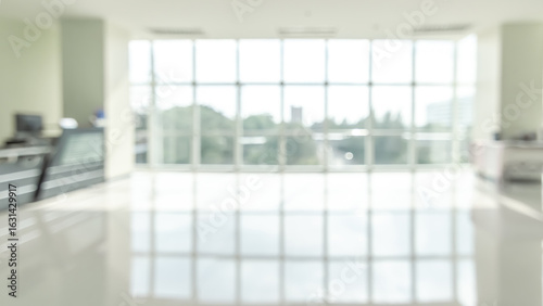 Office building lobby blur background or blurry business reception hall, school hallway interior view, blurred empty corridor, glass curtain wall and floor with exterior light illumination