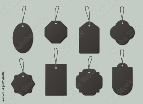 Black price tag collection with string attachments for discount labels or retail displays. Kraft paper shapes designs with cord loops. Blank vintage tags for sales advertise or product marking.