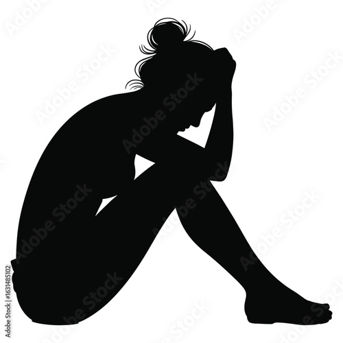 Woman sitting in despair silhouette