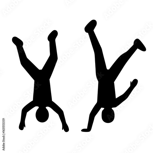 Two people doing handstands silhouette