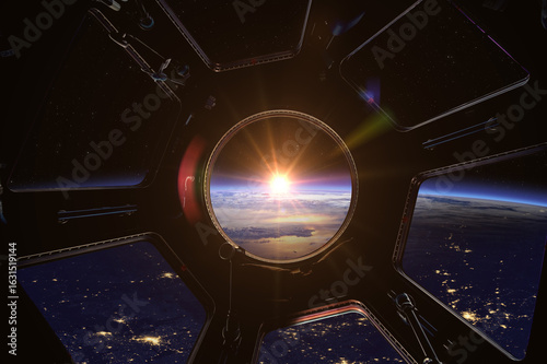 Earth in spaceship international space station porthole. Travel and tourists in space, concept. Planet Earth and Sun in window space station.