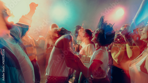 Photos Vibrant dance party with people enjoying music, colorful lights create dynamic atmosphere, motion blur adds energy