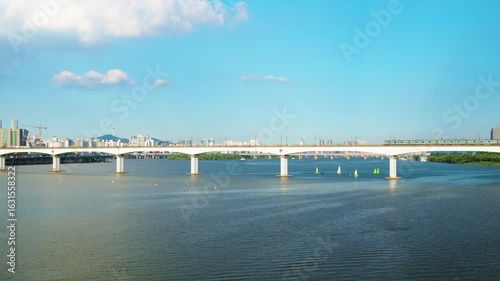 Wallpaper Mural Two subway trains traveling in opposite directions meet in the middle of the Dangsan Railway Bridge over the Hangang River, with the iconic Namsan Tower and Seoul skyline in background Torontodigital.ca