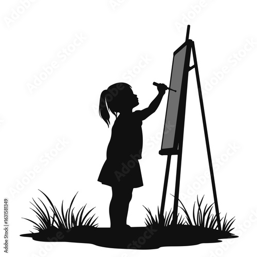 Child drawing on easel in silhouette, creativity and expression