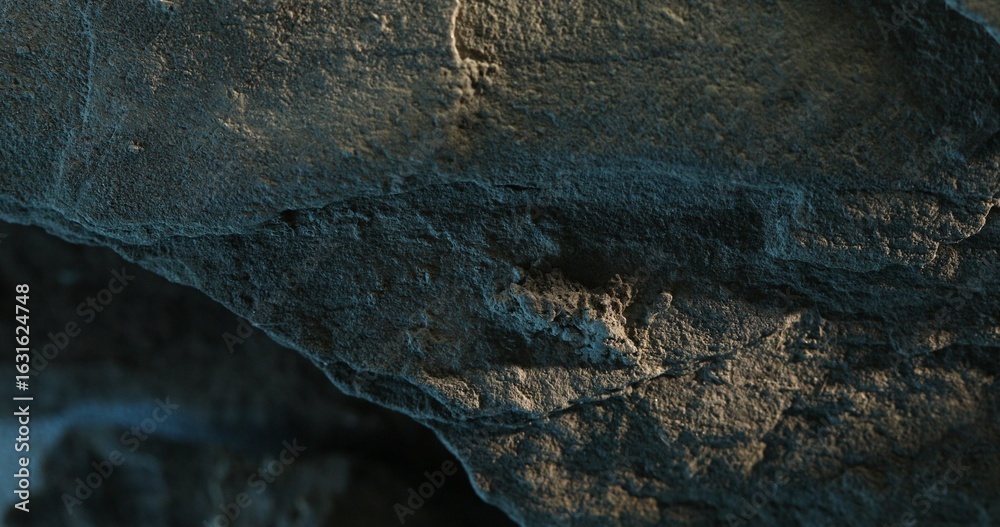 Fototapeta premium Close-up of eroded rock surface with vertical streaks and rough textures