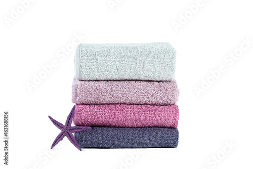 Stack of colorful clean towels and starfish. Isolated on white.