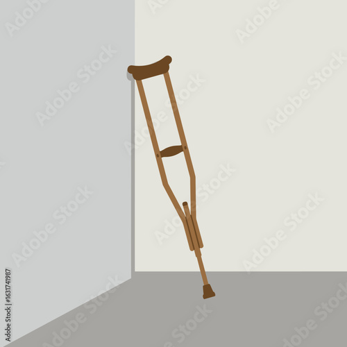Wooden crutch leaning against a minimalistic wall in a serene indoor setting