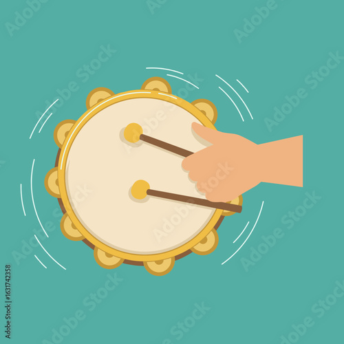 Hand playing a tambourine against a vibrant teal background, creating music and joy