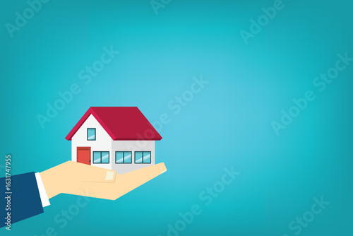 Hand holding house