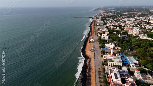 Early morning aerial footage shows the Pondycherry city, Gandhi statue. the entirety of Puducherry, a lighthouse. The Bengal Bay waves. aerial footage of the city and the sea