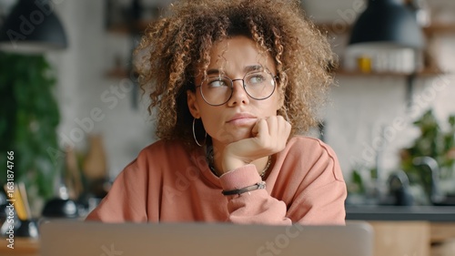 Student engages with financial aid webinar while contemplating debt management strategies